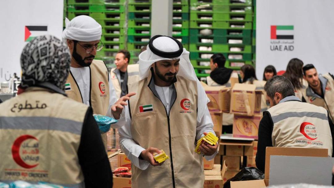 Volunteers from Emirates Red Crescent prepare parcels with humanitarian aid for Gaza to be transferred through the Rafah border crossing between Egypt and the Gaza Strip, in Cairo, Egypt, March 30, 2024.